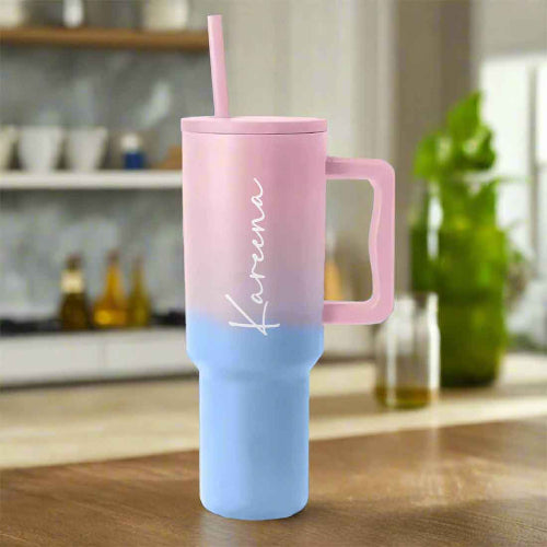 Pink and blue tumbler with handle on a kitchen counter